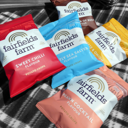 A range of Fairfields Farm crisps on a picnic blanket shot from the top down